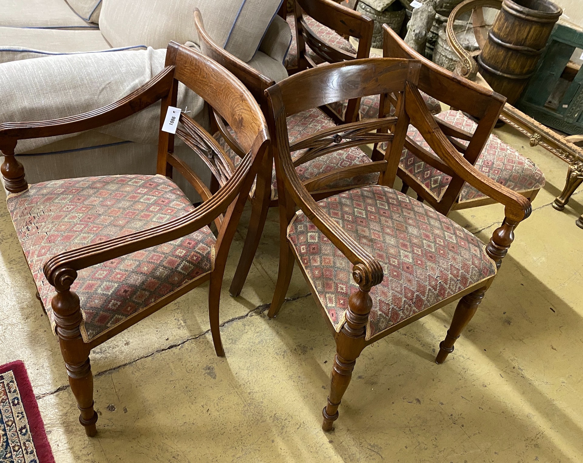 A set of six Indonesian hardwood dining chairs, two with arms